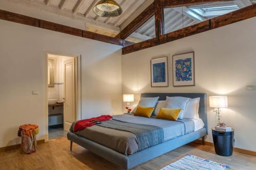 a bedroom with a bed and a ceiling with beams at Apartments Florence Borgo San Lorenzo Terrace in Florence