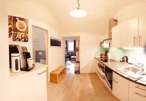 a kitchen with white cabinets and a counter top at Apartment Haus Braumandl in Bad Ischl