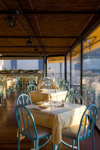 a group of tables and chairs in a restaurant at Hotel La Primavera in Massa Lubrense