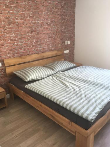 a bed in a room with a brick wall at Galeb in Vodice