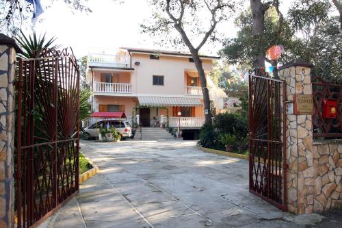 an entrance to a house with an iron gate at Villa Robinia in Massafra
