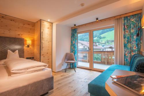 Postel nebo postele na pokoji v ubytování Hotel Tipotsch