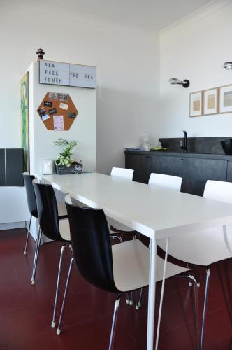 a conference room with a white table and chairs at SEA THE SEA - FEEL THE SEA - TOUCH THE SEA in Bredene