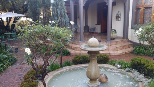 a fountain in the yard of a house at A La Maison Boutique Guesthouse in Parys