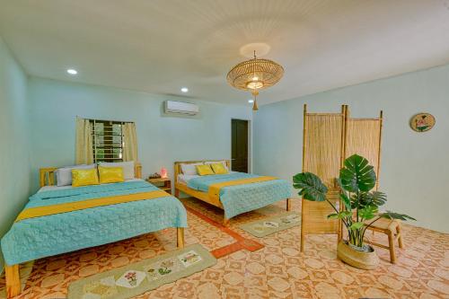 Ένα ή περισσότερα κρεβάτια σε δωμάτιο στο Le Robinet Homestay
