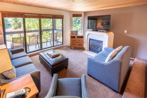 a living room with a couch and a fireplace at The Ironwood on Blueberry Hill in Whistler
