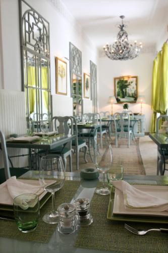 a dining room with tables and chairs and a chandelier at Riad Idra in Marrakech
