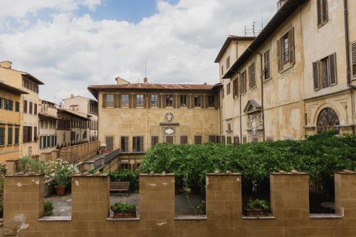 an old building with plants in front of it at The Artists' Palace Florence in Florence