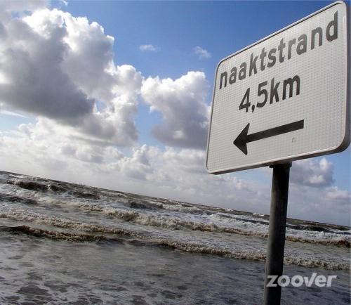 a sign on the beach with the ocean in the background at SEA THE SEA - FEEL THE SEA - TOUCH THE SEA in Bredene