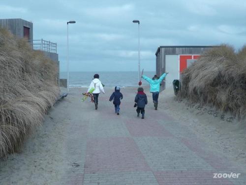 a group of people walking down the beach at SEA THE SEA - FEEL THE SEA - TOUCH THE SEA in Bredene