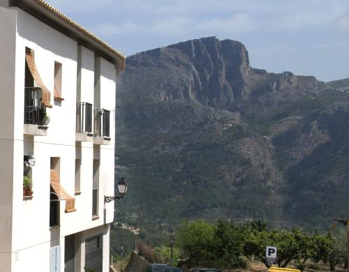 a building with a mountain in the background at APARTAMENTOS SERRELLA - Rural Guadalest in Benimantell