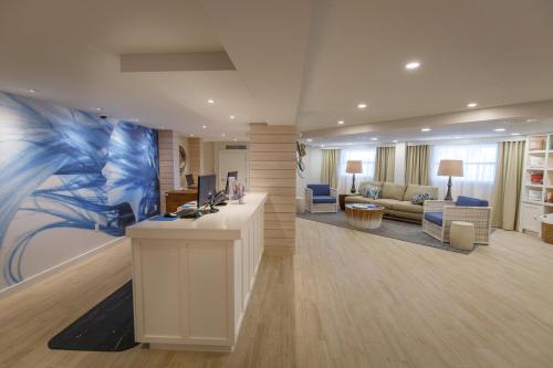 a lobby with a reception desk and a living room at Beach House Suites by the Don CeSar in St Pete Beach
