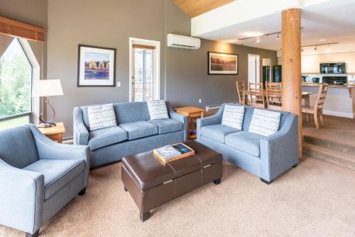 a living room with two couches and a table at The Ironwood on Blueberry Hill in Whistler