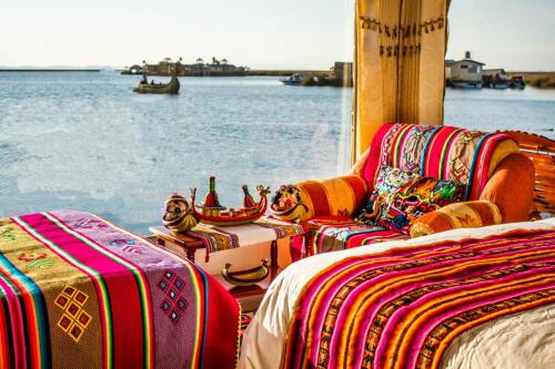 a group of beds on a boat near the water at Luz del Titicaca Lodge in Puno