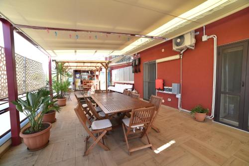 a dining room with a table and chairs on a balcony at B&B Patty's House in Adrano