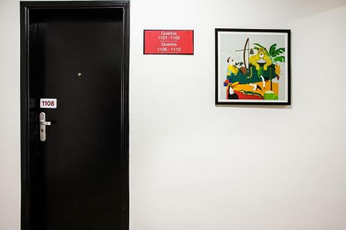 a door with a sign on it next to a picture at Hotel InterAmericana in Americana