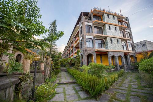 an old building with a walkway in front of it at Hotel Tiosh Abaj in Santiago Atitlán