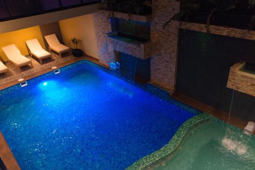 una piscina en un hotel con sillas alrededor en Hotel Paradis Suite Cusco, en Cusco