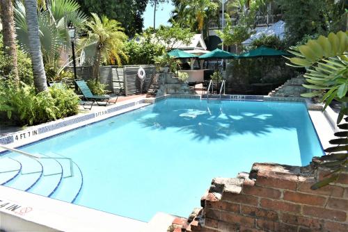 a large blue swimming pool with a brick wall at Simonton Court Historic Inn & Cottages in Key West