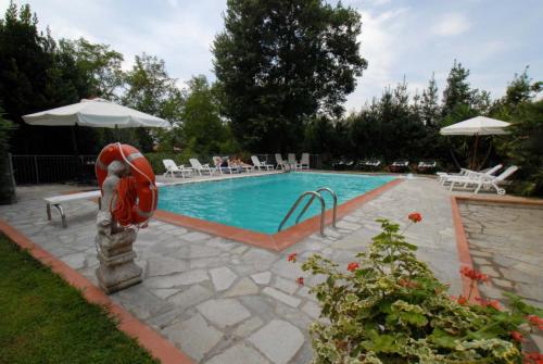 a swimming pool with a red life preserver in a yard at Maison Brinati Bed and Breakfast in Monsummano