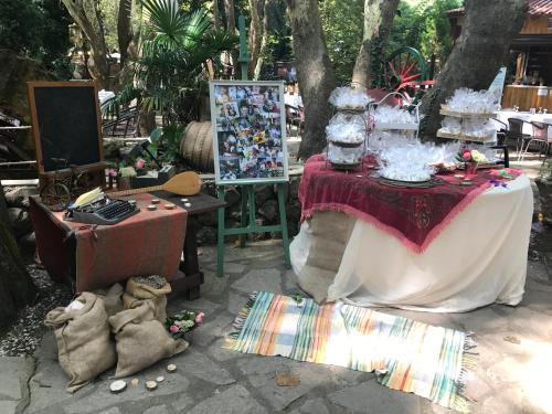 a table with a table cloth and a cake on it at Margaret's Island Hotel in Naousa Imathias