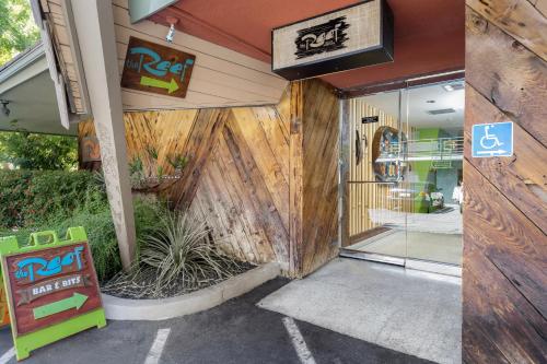 a front door of a restaurant with a wooden wall at Caliente Tropics in Palm Springs