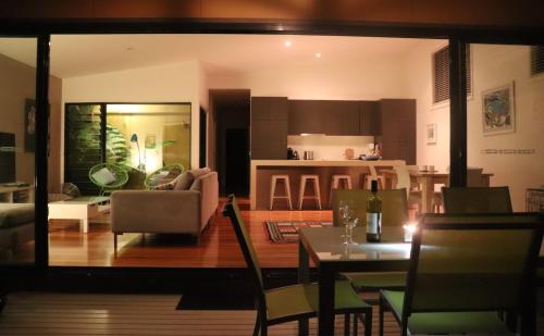 a living room and kitchen with a table and chairs at @LIZZIE in Elizabeth Beach