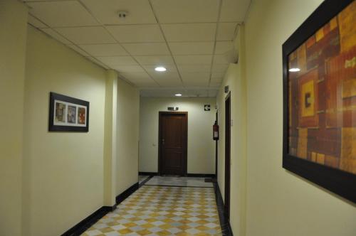 a hallway with a door and a tile floor at Apartamentos Luxsevilla Palacio in Seville