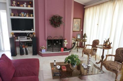 a living room with a couch and a fire place at Sea Side Villa Alexandra in Alissos