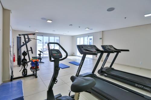 a gym with treadmills and bikes in a room at Nobile Inn London Anápolis in Anápolis
