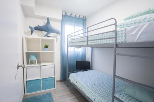波多黎多德薩貢托的住宿－Apartamento en primera línea en Puerto de Sagunto，一间小卧室,配有一张双层床和一张双层床