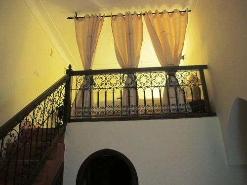 a railing with curtains on top of a staircase at Riad Al Loune in Marrakech