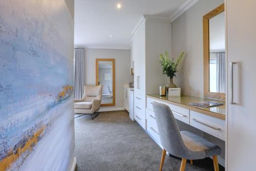 a home office with a desk and a chair at Bay Lodge on the Beach in Mossel Bay