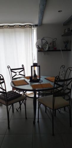 a dining room table with a laptop on top of it at Gite chez mamiyo gallargues le montueux in Gallargues-Le-Montueux