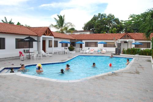 a group of people playing in a swimming pool at Hotel Villa Ricaurte in Girardot