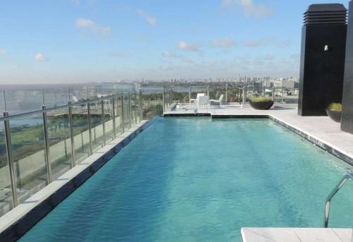 a large swimming pool on top of a building at star apartment olivos in Olivos