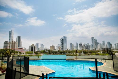 a swimming pool with a city skyline in the background at Horizon Apartment in Cartagena de Indias