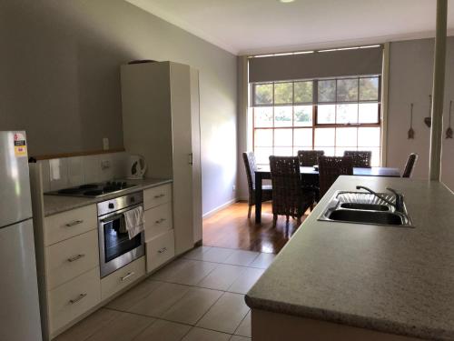 a kitchen with a sink and a counter top at The Old Coolstore - Jonathon Apartment in Merricks North