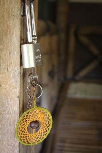 a door lock with a donut hanging from it at Harrys Oceanhouse 2 Pacitan in Pacitan