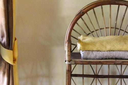 a wooden chair with a pillow on top of it at Harrys Oceanhouse 2 Pacitan in Pacitan