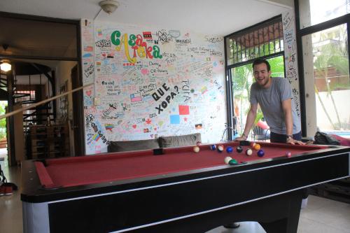 a man standing in front of a pool table at Casa Areka in Panama City