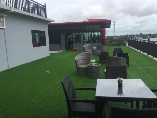 a patio with chairs and tables on a lawn at S.S.Hotel Nangrong in Nang Rong