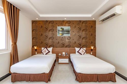 Кровать или кровати в номере Phung Hung Boutique Hotel