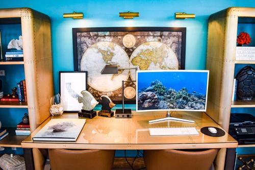 a desk with a computer on top of it at Beachside Inn in Santa Barbara