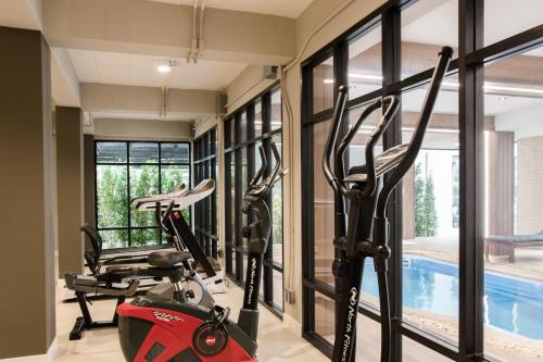 a gym with two bikes and a swimming pool at B Stay Hotel in Bangkok