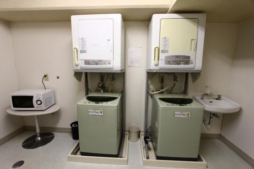 a small bathroom with a sink and a microwave at Central Hotel in Yokosuka