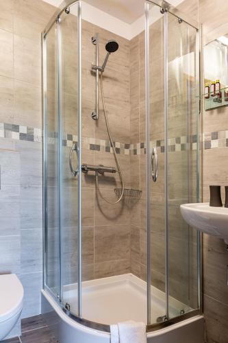 a bathroom with a shower and a sink at Ariston in Karpacz
