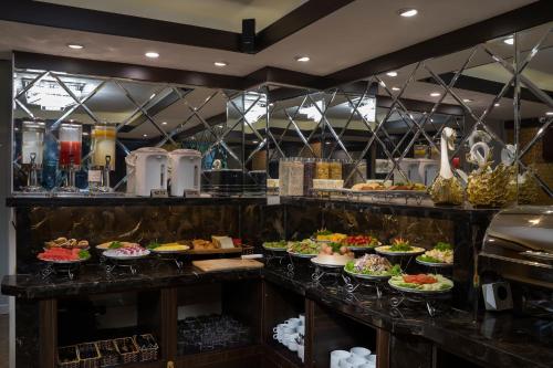 a kitchen filled with lots of different types of food at Splendid Star Grand Hotel and Spa in Hanoi