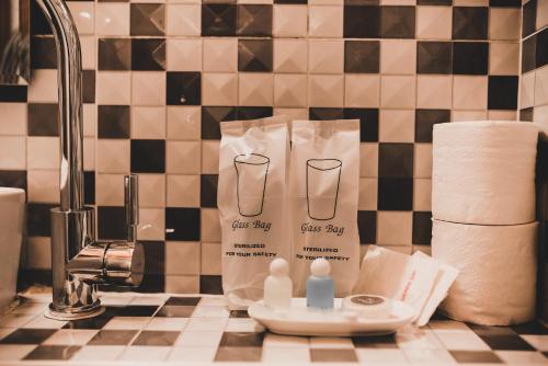 a bathroom counter with toilet paper and a bottle of soap at Luxury Camp@Green Jungle Park in Luang Prabang