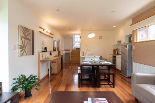 a kitchen and living room with a table in a room at Shinsetsu in Kutchan